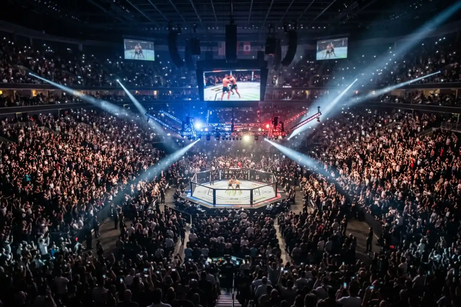 Packed UFC arena with fans watching a live MMA event under bright lights